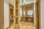 This stunning property boasts a warm and inviting interior with beautiful wooden accents throughout.