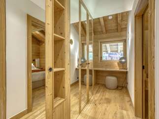This stunning property boasts a warm and inviting interior with beautiful wooden accents throughout.