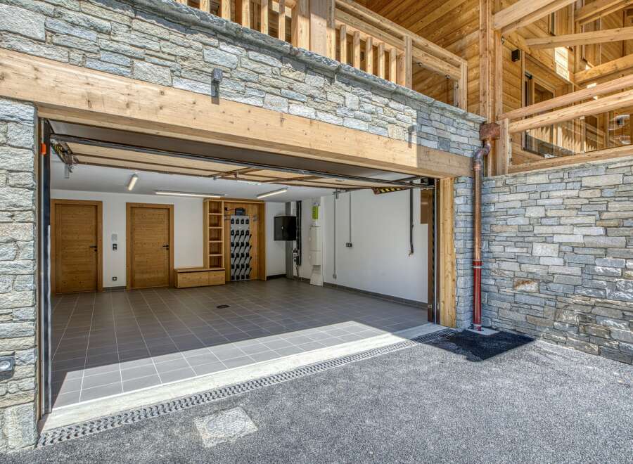 Discover the epitome of luxury living with this stunning property, featuring a spacious garage with ample room for vehicles and storage.