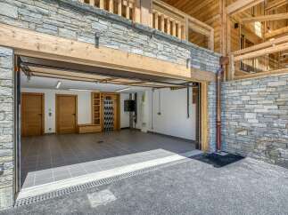Discover the epitome of luxury living with this stunning property, featuring a spacious garage with ample room for vehicles and storage.