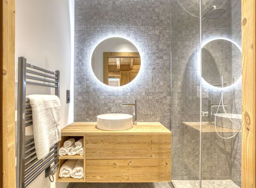 This stunning bathroom boasts a modern design with a touch of rustic charm.