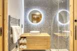This stunning bathroom boasts a modern design with a touch of rustic charm.
