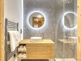 This stunning bathroom boasts a modern design with a touch of rustic charm.