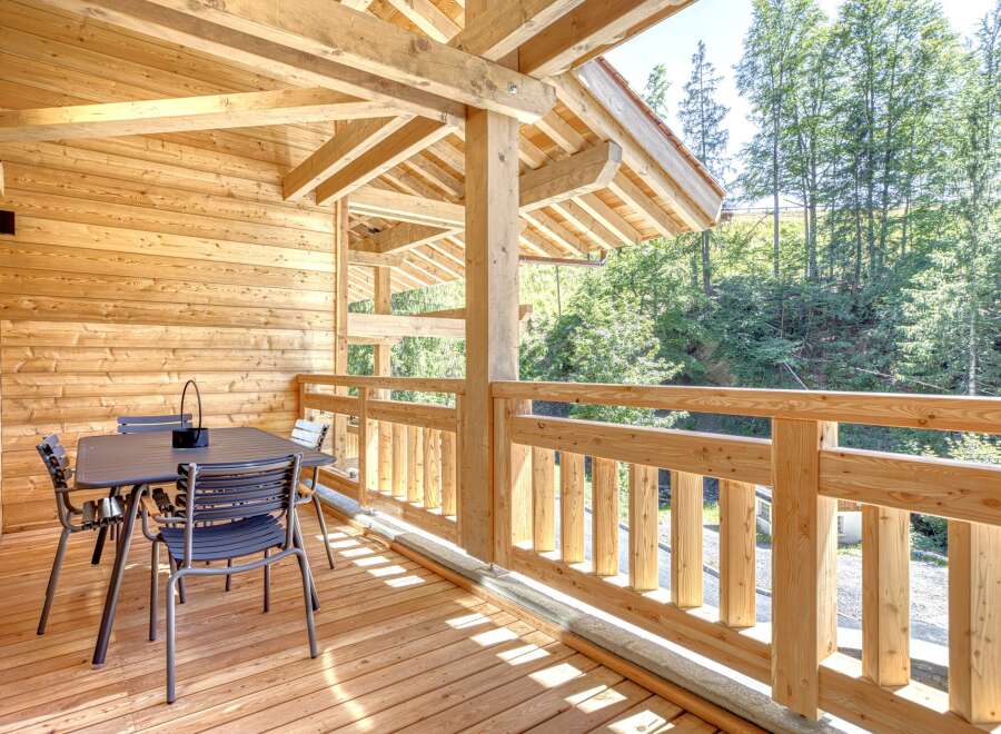 Enjoy the tranquility of this stunning wooden balcony, perfect for relaxing and taking in the surrounding natural beauty.