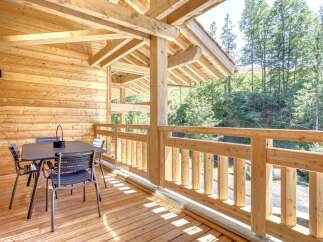 Enjoy the tranquility of this stunning wooden balcony, perfect for relaxing and taking in the surrounding natural beauty.
