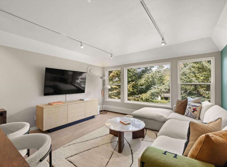 Experience luxury living in this stunning property, featuring a modern living room with a sleek design.