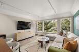Experience luxury living in this stunning property, featuring a modern living room with a sleek design.