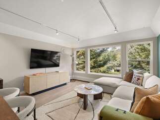 Experience luxury living in this stunning property, featuring a modern living room with a sleek design.