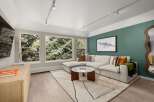Step into luxury with this stunning living room, featuring a modern sectional sofa and a chic coffee table.
