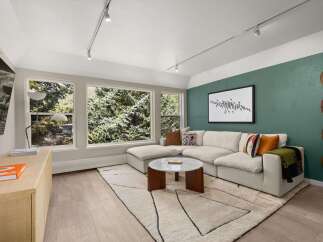 Step into luxury with this stunning living room, featuring a modern sectional sofa and a chic coffee table.