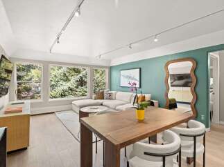 Step into modern elegance with this stunning property, featuring a spacious living area bathed in natural light.