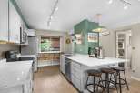 This stunning kitchen boasts a modern design with sleek white cabinetry and stainless steel appliances.