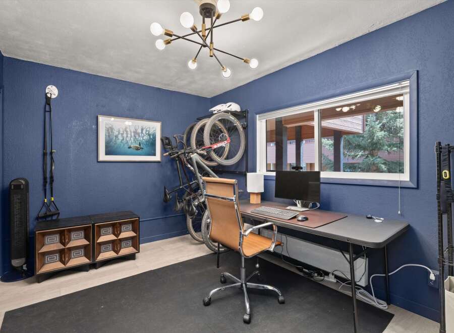 This home office space is designed for productivity and fitness.