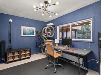 This home office space is designed for productivity and fitness.