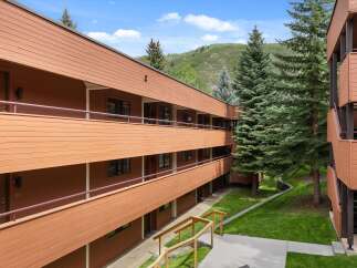 Discover a charming multi-story building with a warm, inviting exterior.