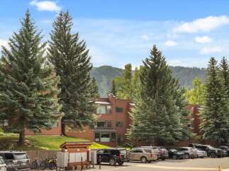 Discover a charming property nestled amidst lush greenery and stunning mountain views.