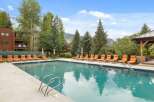 Enjoy the ultimate relaxation at this stunning property featuring a sparkling pool and comfortable lounge chairs.