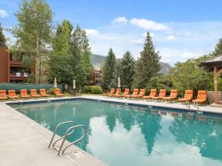 Enjoy the ultimate relaxation at this stunning property featuring a sparkling pool and comfortable lounge chairs.