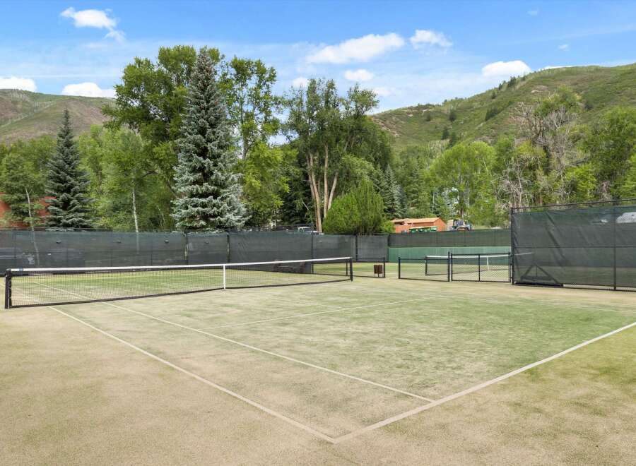 Enjoy the ultimate outdoor experience with this stunning tennis court.