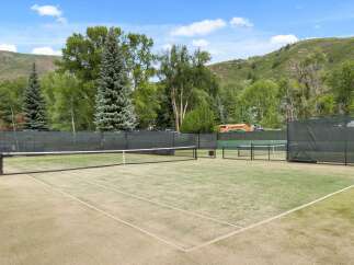 Enjoy the ultimate outdoor experience with this stunning tennis court.