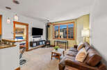 Step into this inviting living space, featuring a cozy fireplace and a stylish leather sofa, perfect for relaxing evenings.
