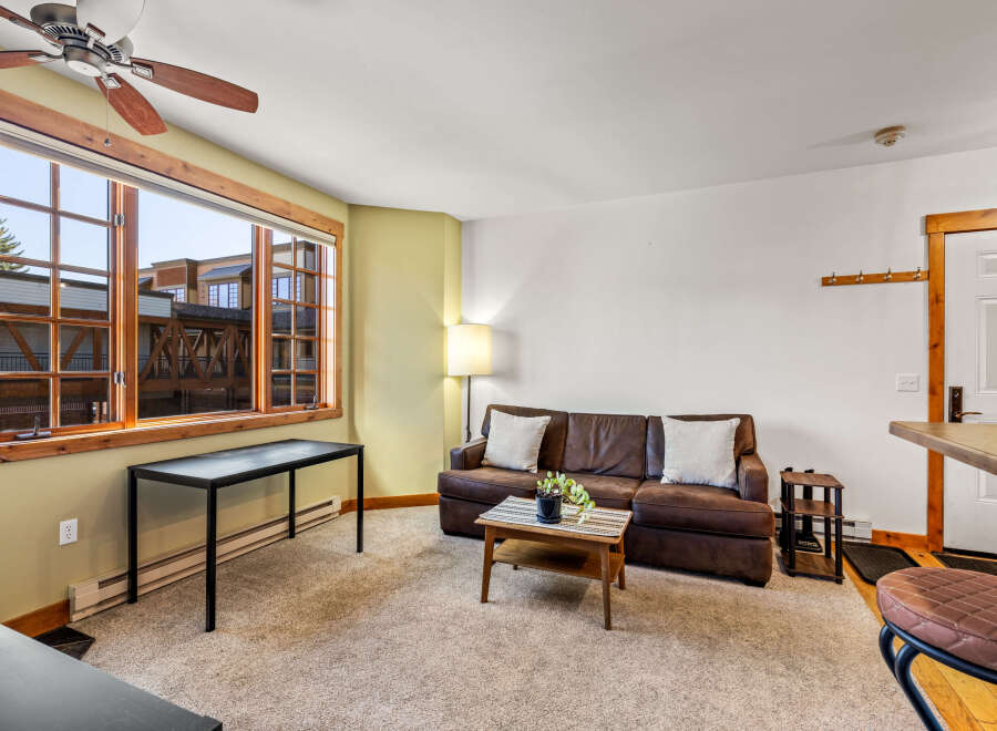 This cozy living space features a comfortable brown leather sofa, perfect for relaxing.