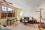 This cozy living space features a comfortable brown leather sofa, perfect for relaxing.