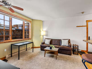 This cozy living space features a comfortable brown leather sofa, perfect for relaxing.