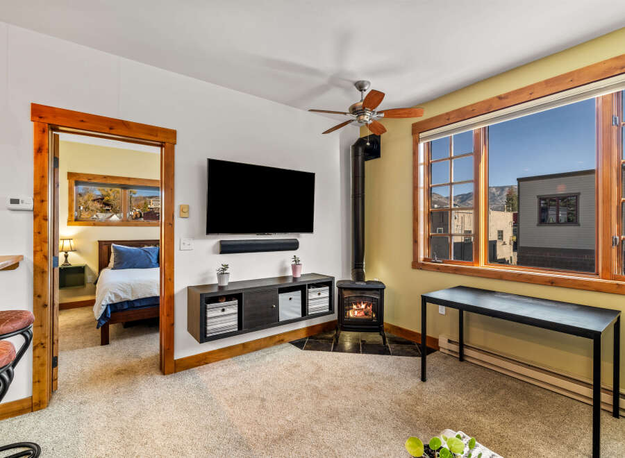 This cozy living space features a mounted TV, perfect for entertainment.