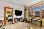 This cozy living space features a mounted TV, perfect for entertainment.