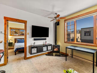 This cozy living space features a mounted TV, perfect for entertainment.