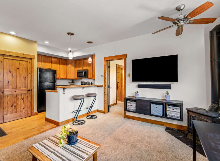 Step into this inviting living space, featuring a cozy fireplace and a modern entertainment setup.