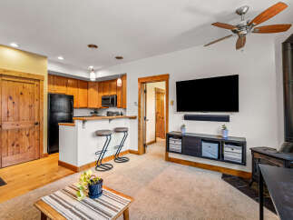 Step into this inviting living space, featuring a cozy fireplace and a modern entertainment setup.