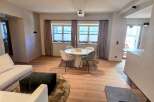 Experience modern elegance in this stunning living space, featuring a cozy seating area and a stylish dining setup.