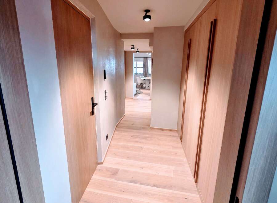 Step into a world of modern elegance with this stunning hallway.