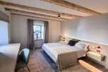 Experience the charm of this beautifully designed bedroom, featuring exposed wooden beams that add a touch of rustic elegance.
