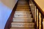 This stunning staircase is a focal point of the home, featuring beautiful wooden steps and a rich, dark wood railing.