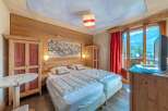 Experience the charm of this cozy bedroom featuring wooden accents and a serene ambiance.