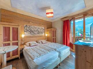 Experience the charm of this cozy bedroom featuring wooden accents and a serene ambiance.