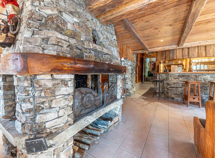 Experience rustic charm in this stunning property featuring a magnificent stone fireplace, perfect for cozy evenings.