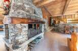 Experience rustic charm in this stunning property featuring a magnificent stone fireplace, perfect for cozy evenings.