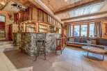 This stunning property boasts a rustic charm with its wooden interior and stone accents.