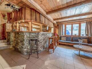 This stunning property boasts a rustic charm with its wooden interior and stone accents.