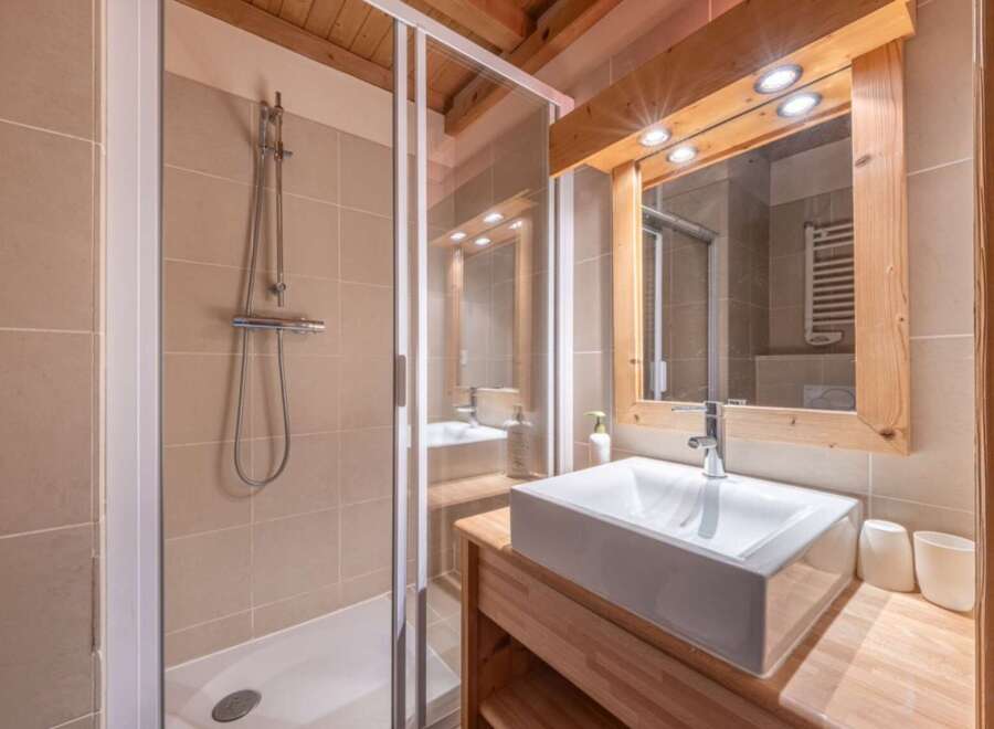 This stunning bathroom features a modern design with a sleek shower and a stylish sink.