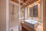 This stunning bathroom features a modern design with a sleek shower and a stylish sink.