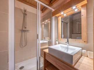 This stunning bathroom features a modern design with a sleek shower and a stylish sink.