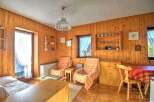 Step into a cozy retreat with this charming property, featuring warm wooden paneling throughout.