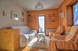 Cozy living space with wooden paneling and a comfortable sofa.