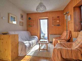 Cozy living space with wooden paneling and a comfortable sofa.