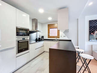 Discover modern living in this stylish kitchen! Featuring sleek, white cabinetry and stainless steel appliances, this space is perfect for culinary enthusiasts.